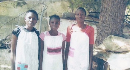 Girls from Nigeria wearing the pillowcase dresses they received.