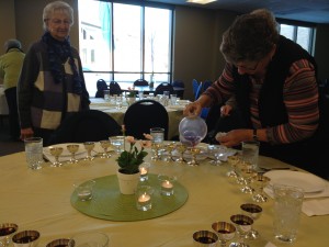 Grape juice was distributed into four cups at each place setting.