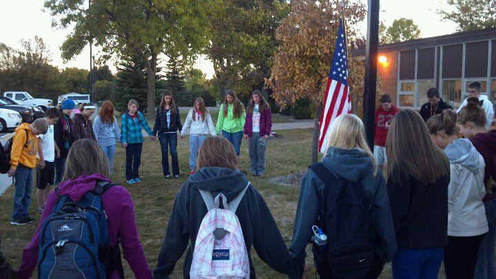 Students praying before a school day for See You at the Pole in Hutchinson (2012).
