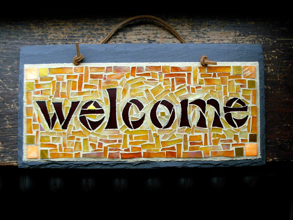 "Welcome Sign Mosaic in Warm Tones" by Nutmeg Designs is licensed under CC BY-NC-ND 2.0.